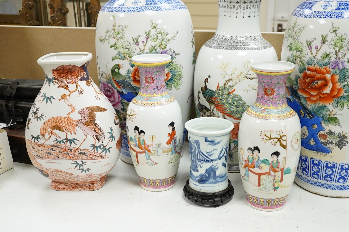 A large pair of Chinese polychrome vases, 60cm high, a pair of famille rose vases, a blue and white brushpot and two other vases (7).